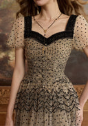 Lace mesh dress bodice detail with dark square neckline trim and dotted sheer puff sleeves