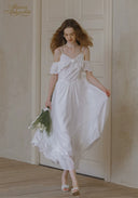 White lace midi dress with off-shoulder ruffle detail and thin straps, full skirt