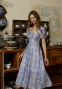 Light blue floral midi dress with puff sleeves and lace-trim square neckline, standing pose