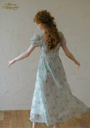 Light blue floral midi dress with puff sleeves, gathered waist, full skirt flare