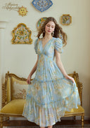 Light blue floral midi dress with puff sleeves and tiered skirt