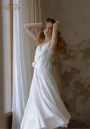 White lace midi dress with thin straps and ruffled waist, flowing A-line skirt