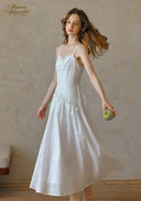 White lace cami dress with spaghetti straps and flared skirt in a midi length