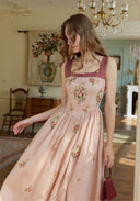 Pink linen maxi dress seen from back three-quarter view with floral embroidery