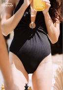 Black cut-out halter one-piece swimsuit with center ring; draped front