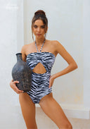 One-piece zebra-print swimsuit with halter straps and front oval cutout