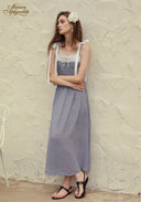 Blue patterned midi dress with lace-trim square neckline and white ribbon bows on straps