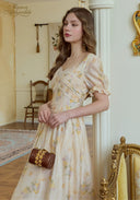 Cream floral midi dress with puff sleeves, cinched waist, and gathered skirt