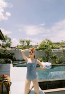 Light blue one-piece swimsuit with center lace-up closure and thin straps