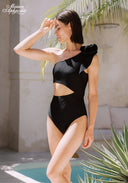 Black one-shoulder swimsuit with bow detail at shoulder and high-cut bottom