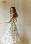 Floral dress with puff sleeves, gathered waist, and full skirt, white with pink details