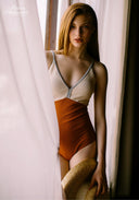 Orange and cream one-piece swimsuit with V-neck front and slim straps