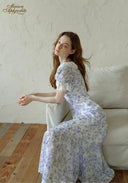 Lavender floral midi dress with puff sleeves and layered ruffled skirt, side view