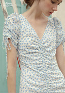 Blue Celeste floral dress close-up with V-neck, ruched fabric and fringe sleeve ties