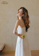 White spaghetti-strap dress with lace bodice and gathered, flowing skirt