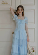 Light blue square-neck lace dress with puff sleeves and tiered midi skirt.