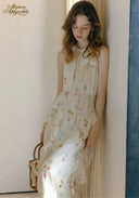Floral sleeveless midi dress with layered skirt tiers and pleated bodice, round neckline