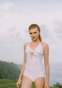 White one-piece swimsuit with pearl bow detail and keyhole neckline