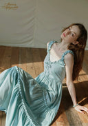 Light blue tiered midi dress with lace-trim neckline and ruffled spaghetti straps, gathered skirt