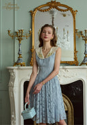 Light blue sleeveless lace patchwork dress with V-neck and fitted waist to flared skirt