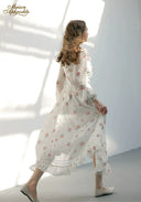 Floral midi dress in an all-over print, viewed from the back with long sleeves