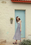Blue patterned midi dress with lace-trim bodice, thin ribbon straps, and tie details