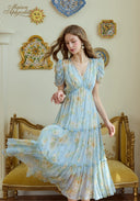Light blue floral midi dress with puff sleeves and tiered skirt, layered hem