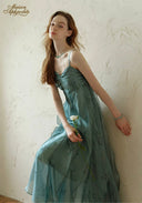 Teal satin midi dress with ruched bodice and spaghetti straps, leaning pose