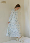 Blue floral tiered maxi dress with long sleeves and tiered skirt, back view.