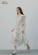 Floral midi dress with ruffled neckline and long sleeves, walking side view