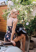Floral black one-piece swimsuit, back view with tie detail at the neck