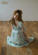 Voile de Sel dress in light blue with pastel floral print, gathered waist, short sleeves