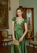 Green satin long dress with lace V neckline, short puff sleeves, fitted waist and gathered skirt