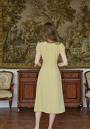 Yellow embroidered dress back view with short sleeves and center back seams