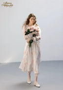 Floral tiered dress in pale pink with ruffled sleeves, full-length front view