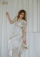 Floral French dress in light white with pastel print, square neckline, puff sleeves, flowing skirt