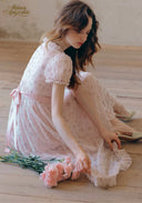 Light pink lace tea dress with puff sleeves and side bow detail