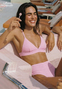 Pink bikini top and high-waist briefs, hand holding the front strap