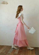 Side view of red and white gingham plaid maxi dress with off-shoulder lace and flared hem