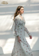 Floral midi dress with long sleeves and tiered skirt, side profile view