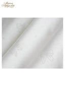 White lace fabric close-up with subtle floral motifs
