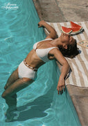 White bikini set with triangle cups and high-waist bottoms, lying side view