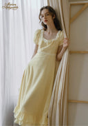 Romance dress detail: square neckline with lace trim and puff sleeves in pale yellow