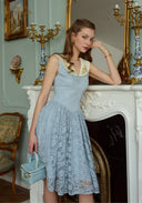Light blue sleeveless lace patchwork dress in side profile with V-neck trim