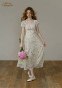 Floral tea dress with square neckline, lace trim, and tiered midi skirt hem