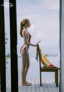 Orange and white striped halter one-piece swimsuit with tie-back detail