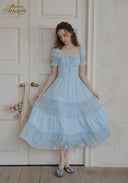 Light blue square-neck lace dress with puff sleeves and tiered ruffle skirt.