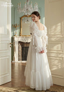 Ivory tiered lace dress with ruffled sleeves and layered floor-length skirt