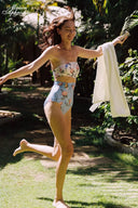 Floral printed bandeau bikini set with matching bikini bottoms, model jumping